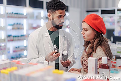 Young pharmacist helping customer to choos medication. Stock Photo