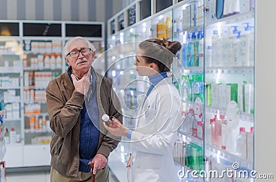 Young pharmacist helping senior man to choos medication. Stock Photo