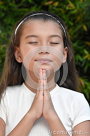 Young Philippina Girl In Prayer Closeup Stock Photo