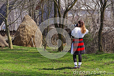 Young photographer dressed in traditional clothes in Maramures county. Stock Photo