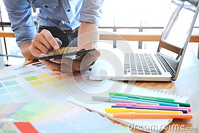 Young photographer and graphic designer at work in studio office Stock Photo