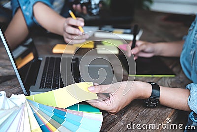 Young photographer and graphic designer at work in studio office Stock Photo