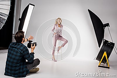 young photographer shooting beautiful stylish young woman Stock Photo