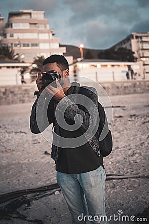 Young photographer taking a photo at gloden hour Editorial Stock Photo