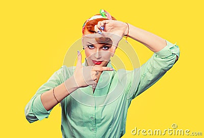 Young pin up retro hair style girl woman making framing key gesture on yellow Stock Photo