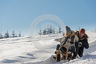 Young playful couple having fun in the snow Stock Photo