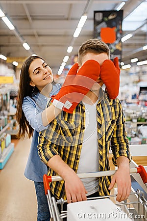 Young playful couple, shopping in houseware store Stock Photo