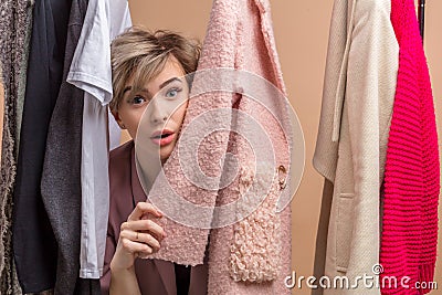 Young pleasant beautiful customer is afraid of sellers Stock Photo