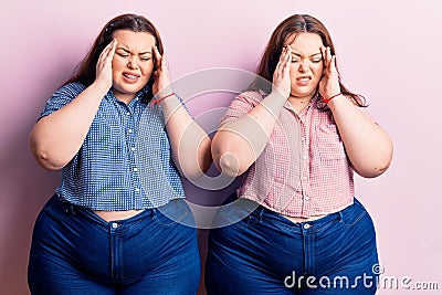 Young plus size twins wearing casual clothes with hand on head, headache because stress Stock Photo