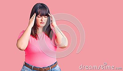 Young plus size woman wearing casual clothes with hand on head for pain in head because stress Stock Photo