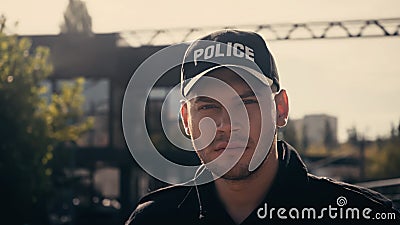 young policeman in cap with police Stock Photo