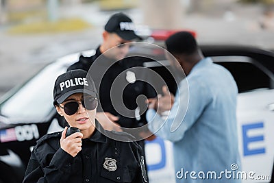 Young policewoman talking on radio set Stock Photo