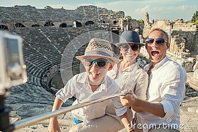 Young positive famly take a vacation photo on the Side ampitheatre view Stock Photo