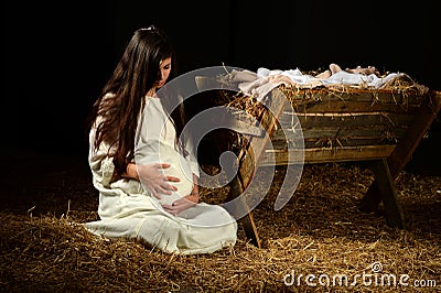 Young Pregnant Mary with Manger Stock Photo