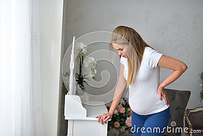 Young pregnant woman feeling heaviness during pregnancy Stock Photo
