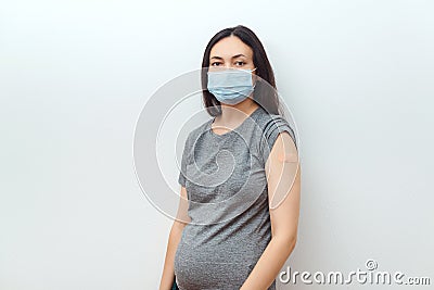 Young pregnant woman getting the coronavirus vaccine. Antibodies, immunize population Stock Photo