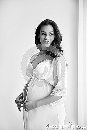 Young pregnant woman in lace nightgown Stock Photo