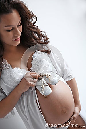 Young pregnant woman in lace nightgown Stock Photo