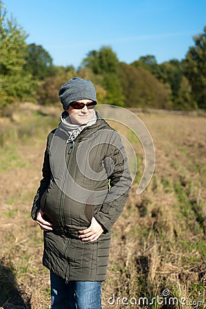 Young pregnant woman outdoor in the autumn Stock Photo