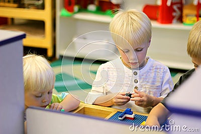 Young Preschool Children Playing Building Blocks in School Class Stock Photo