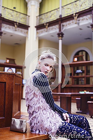 Young pretty blond girl posing in fashion style at vintage europe hall interior, lifestyle rich people concept Stock Photo