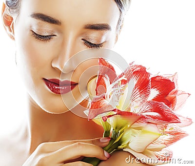 Young pretty brunette real woman with red flower amaryllis close Stock Photo