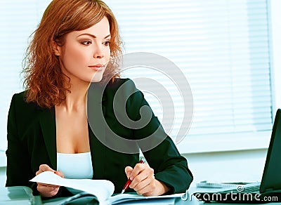 Young pretty business woman in the office Stock Photo