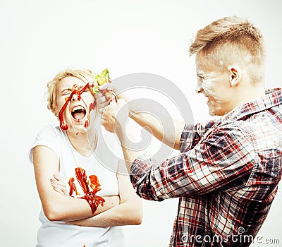 Young pretty couple, lifestyle people concept: girlfriend and boyfriend cooking together, having fun, making mess Stock Photo