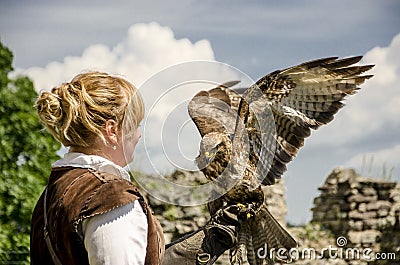 Young pretty Falconer with his falcon, used for falconry, Editorial Stock Photo