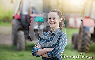 Farmer woman with tractors on farmland Stock Photo