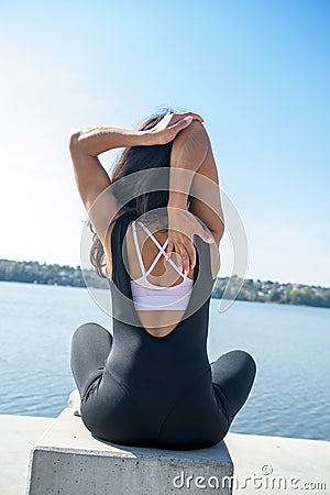 Young pretty fitness woman doing yoga poses, streching in the nature. Healthy lifestyle Stock Photo