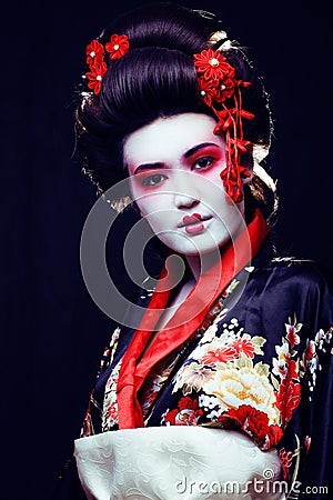 young pretty geisha in kimono with sakura and decoration on blac Stock Photo