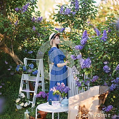 Young beautiful girl in lilac blooming garden Stock Photo