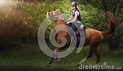 Young pretty girl riding a horse Stock Photo