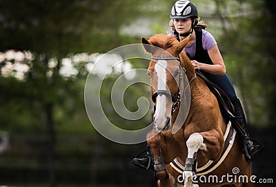 Young pretty girl riding a horse Stock Photo