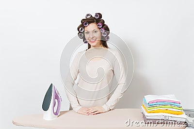 Young pretty housewife. Woman on white background. Housekeeping concept. Copy space for advertisement. Stock Photo