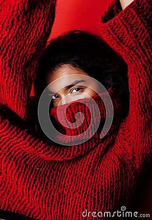 Young pretty indian mulatto girl in red sweater posing emotional, fashion hipster teenage, lifestyle people concept Stock Photo