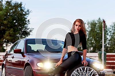 Young pretty lady with a clasic car Stock Photo