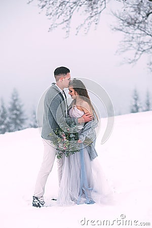 Young pretty pair of lovers. Winter. Date. A pair of lovers on a date in the mountains. Stock Photo