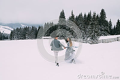 Young pretty pair of lovers. Winter. Date. A pair of lovers on a date in the mountains. Stock Photo