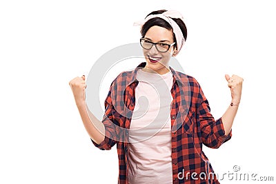 Young pretty pin-up girl wearing glasses showing winning gesture Stock Photo