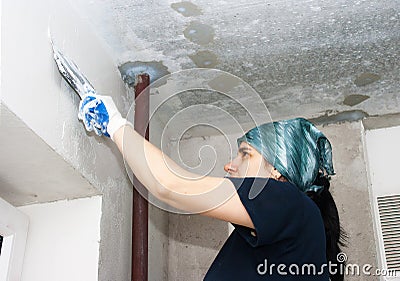 Young pretty woman geting plaster wall Stock Photo