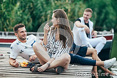 Young pretty woman and handsome man flirting while relax on picnic near river Stock Photo