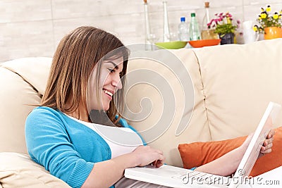 young pretty woman lying bed laptop Stock Photo