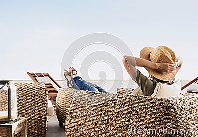 Young woman resting on hotel terrace. Vacations and summer fun concept. Beautiful girl enjoying life Stock Photo