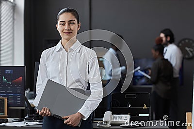 Young professional broker standing in office Stock Photo