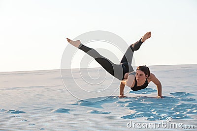 Young professional gymnast woman dance outdoor - sand beach Stock Photo