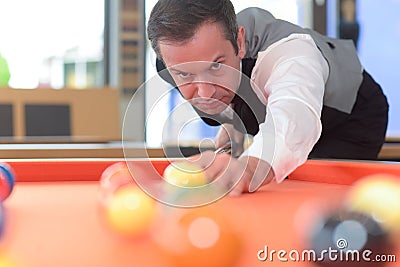 Young professional man playing billard in club Stock Photo