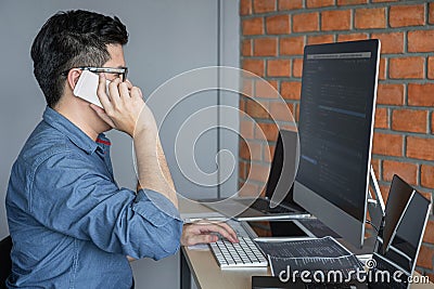 Young Professional programmer working at developing programming and website working in a software develop company office, writing Stock Photo