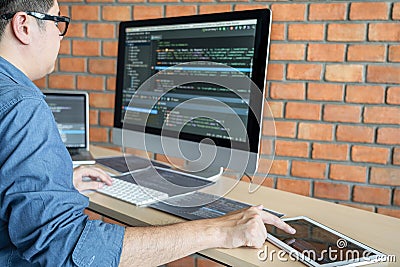 Young Professional programmer working at developing programming and website working in a software develop company office, writing Stock Photo